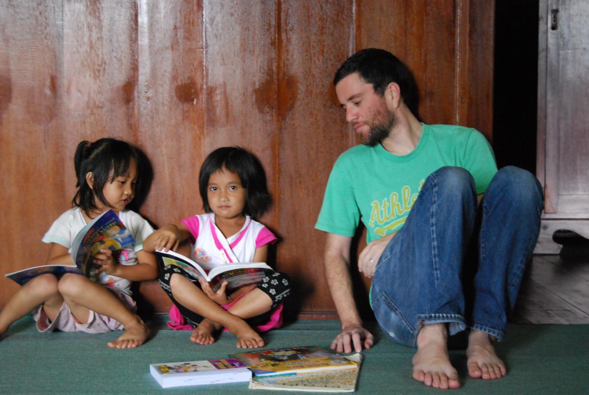 Graduate student Brad McDonnell working with children in Indonesia.