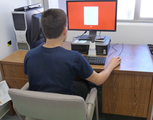 Undergraduate research assistant Mike LaRosa demonstrates an experiment.